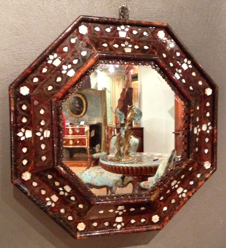 Rare octagonal mirror is canted and inverted profiles. 
Model veneer brown tortoiseshell inlaid engraved mother of pearl and silver. 
Built in ponderosa pine. 
Of record label lady Pean ..... 
Mexico 17th century to the Spanish market.