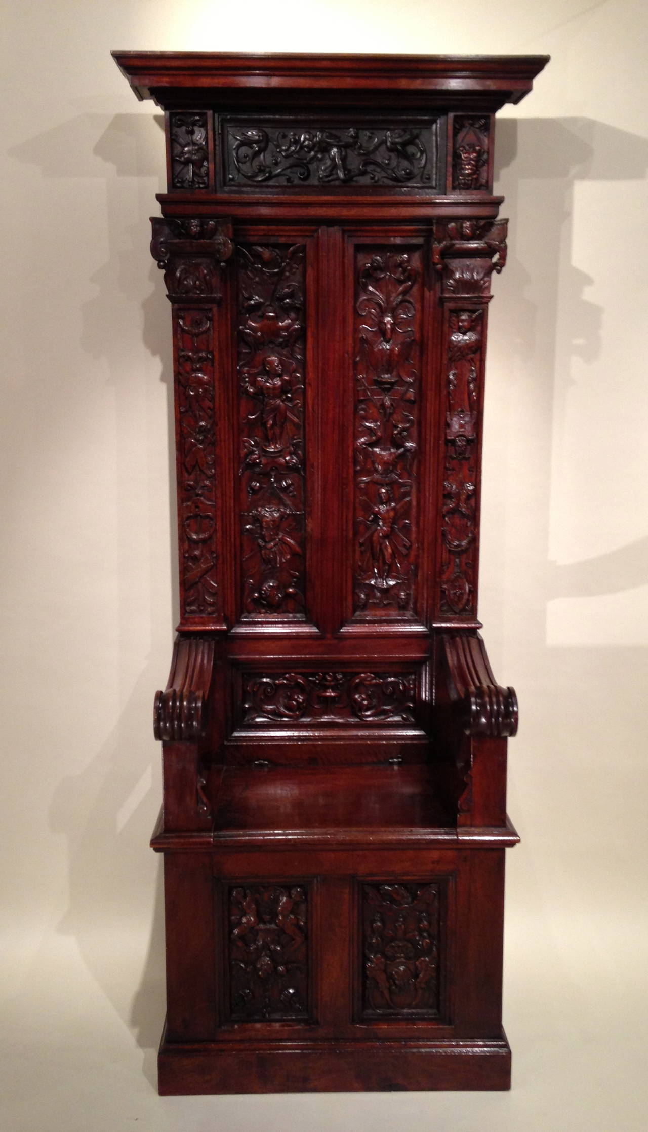 Ceremonial chair high back walnut, linden and ebony carved with the lower part and locker.

The armrests fluted windings.

The file has two framed panels and carved pilasters topped with capitals and cornices.

Arabesque décor, chimeras,