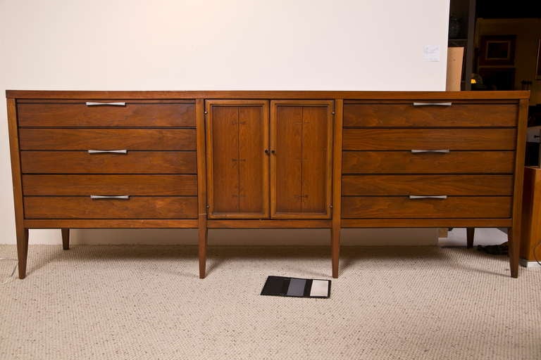 Lovely and special dresser by lane Furniture. Very special design rarey seen. Cohesive design with original hardware which matches inlay. Plenty of storage space. Three drawers on both sides with four center sliding shelves. In great condition with