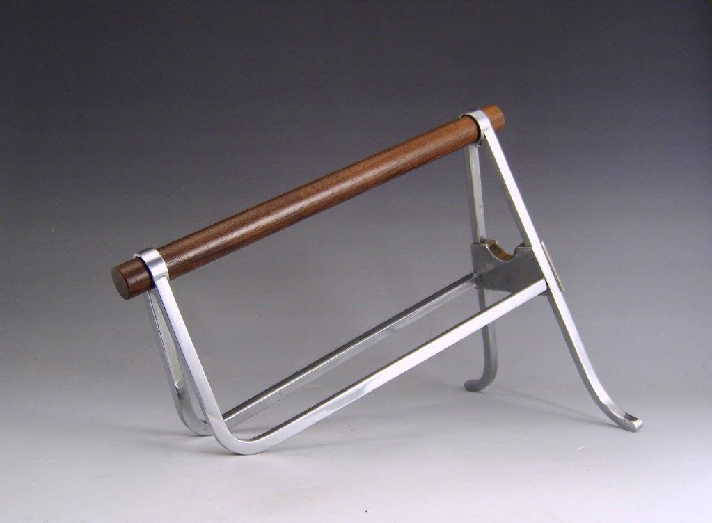 A desirable and stylish Wine bottle stand by Jacques Adnet in chrome plated metal and Mahogany