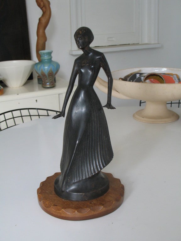 An Art Deco figure of a stylised Dancer by the Dutch Sculptor Thomas Andreas Vos. Signed by Artist and with unknown founders mark