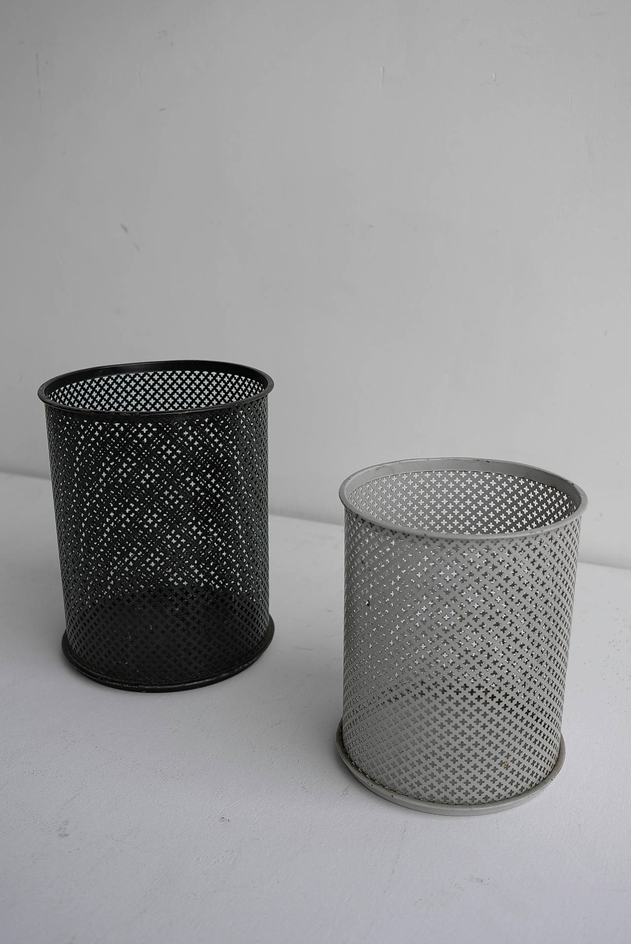 A pair of black and white pervorated metal waste paper baskets.
Designed by Mathieu mategot for Artimeta Soest The Netherlands 1950's.
The black basket is larger than the white.