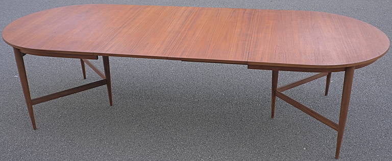 Large Danish dining table by Oswald Vermaercke for V-Form. This table is adjustable in three lengths by two wooden parts. The table has an elegant v shaped base. The teak top and base are in perfect condition.
Length 291cm with the two middle