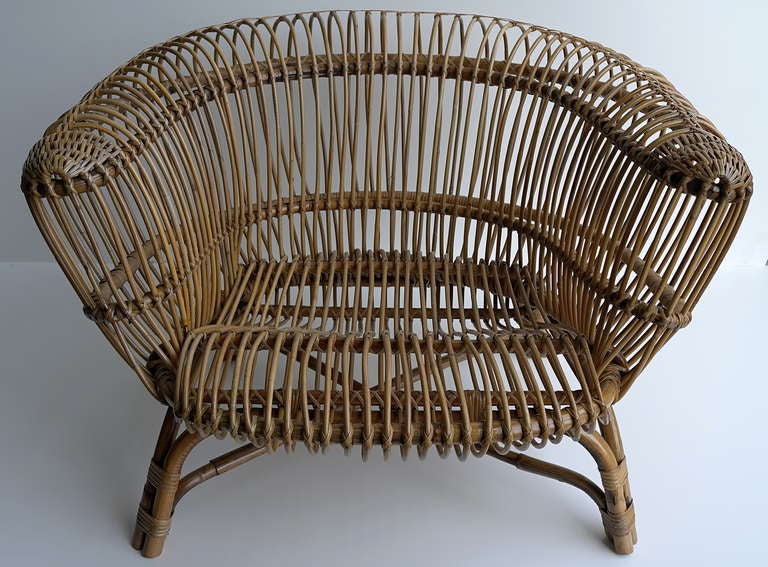 Rare Paolo Tilche. 'Silvia' armchair, 1956. H. 68 cm; 97 x 94 cm. Made by Arform, Italy. Cane wickerwork. 
Pictures 8, 9, 10 taken from the Repertorio del Design Italiano 1950-2000 per L'Arredamento Domestico and the Domus. this work is in line