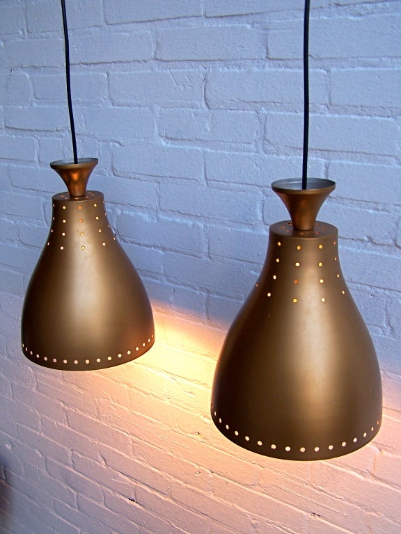 Pair off Danish pendant lights. Lamps are adjustable in height, gives a warm light when lit.