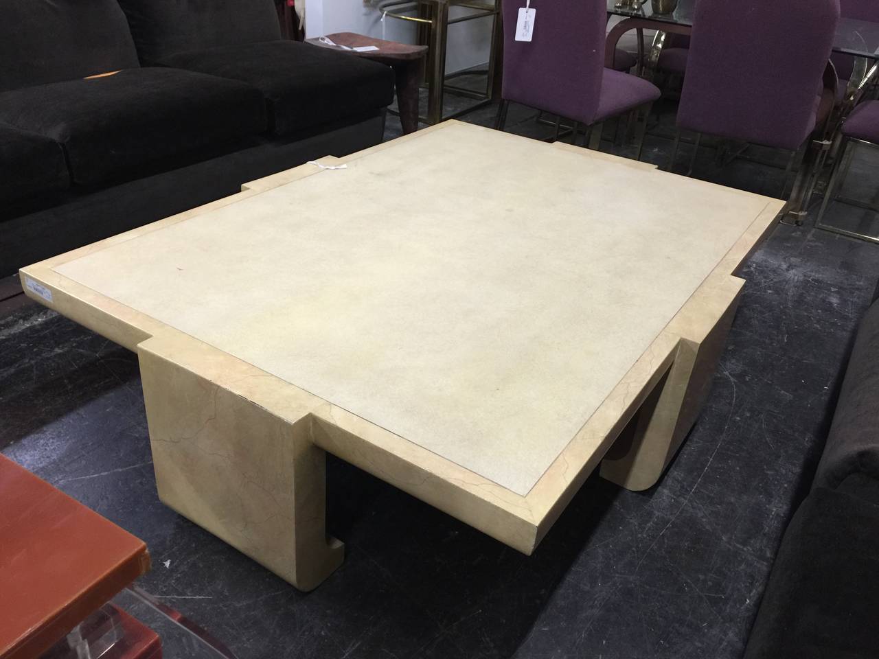 Asian style coffee table by Alessandro for Baker Co. This monumental coffee table is lacquered in beige goatskin around the body of the table with a textured top.

There is some loss around the joint area.

dimensions: 66