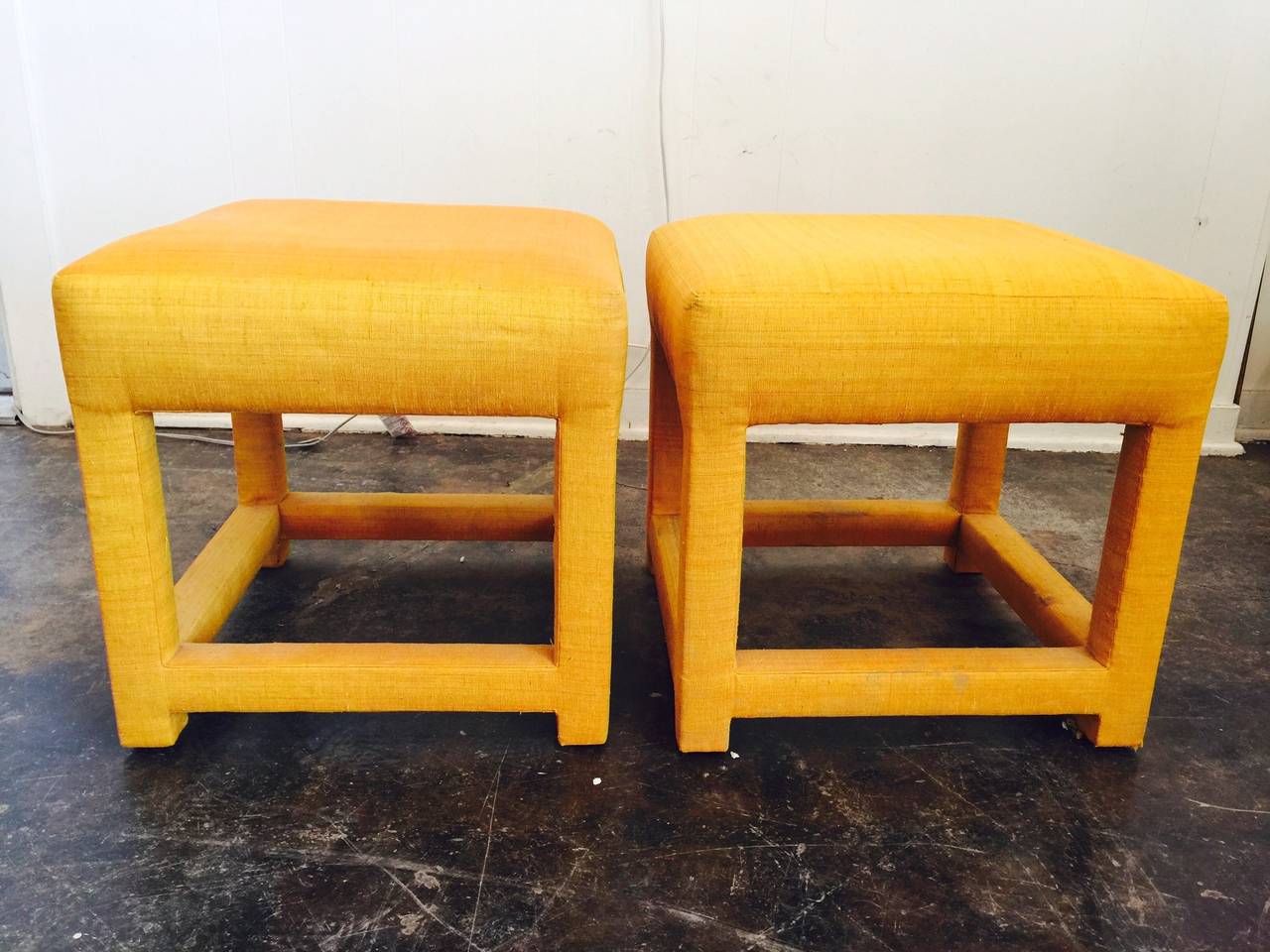 These pair of marigold colored parson stools, in the style of Milo Baughman, can add a pop of color in any room. The upholstery needs cleaning and has a few issues and would recommend new upholstery. 

dimensions: 18.5