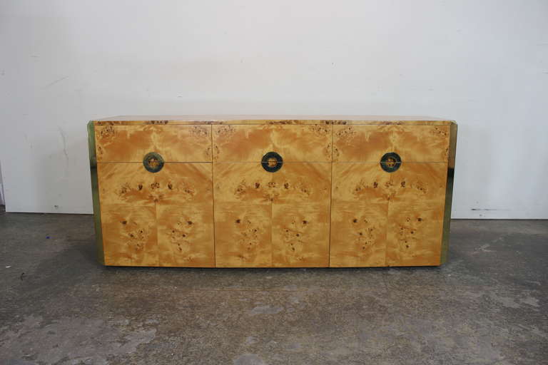 3 Door credenza in exotic burl with brass accents.