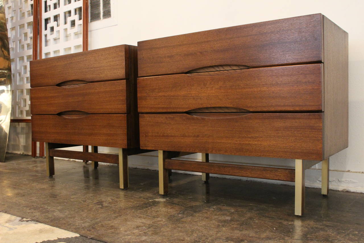 New refinished nights by American of Martinsville. Brown ribbon mahogany with recessed elliptical pulls and brass accents on legs. circa 1950s 

dimensions: 34