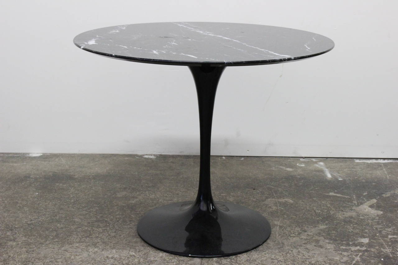 Black marble tulip table by Saarinen. 

dimensions: 35.75