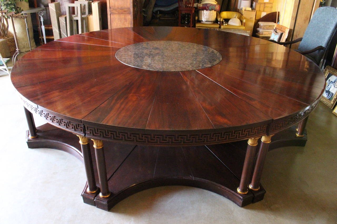 This eight-piece sectional table with marble center came from a luxury hotel in Dallas. Table is mahogany with Greek key scroll work and has columns that are gilded.

Dimensions: 11' diameter x 32