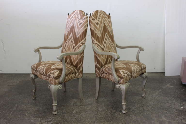 Pair of handsome armchairs upholstered in an chevron ikat patterned fabric. Perfect as captain chairs in dining room or occasional chairs in the living room. The dimensions are 24.5" wide 19" deep 43.5" tall with a seat height of