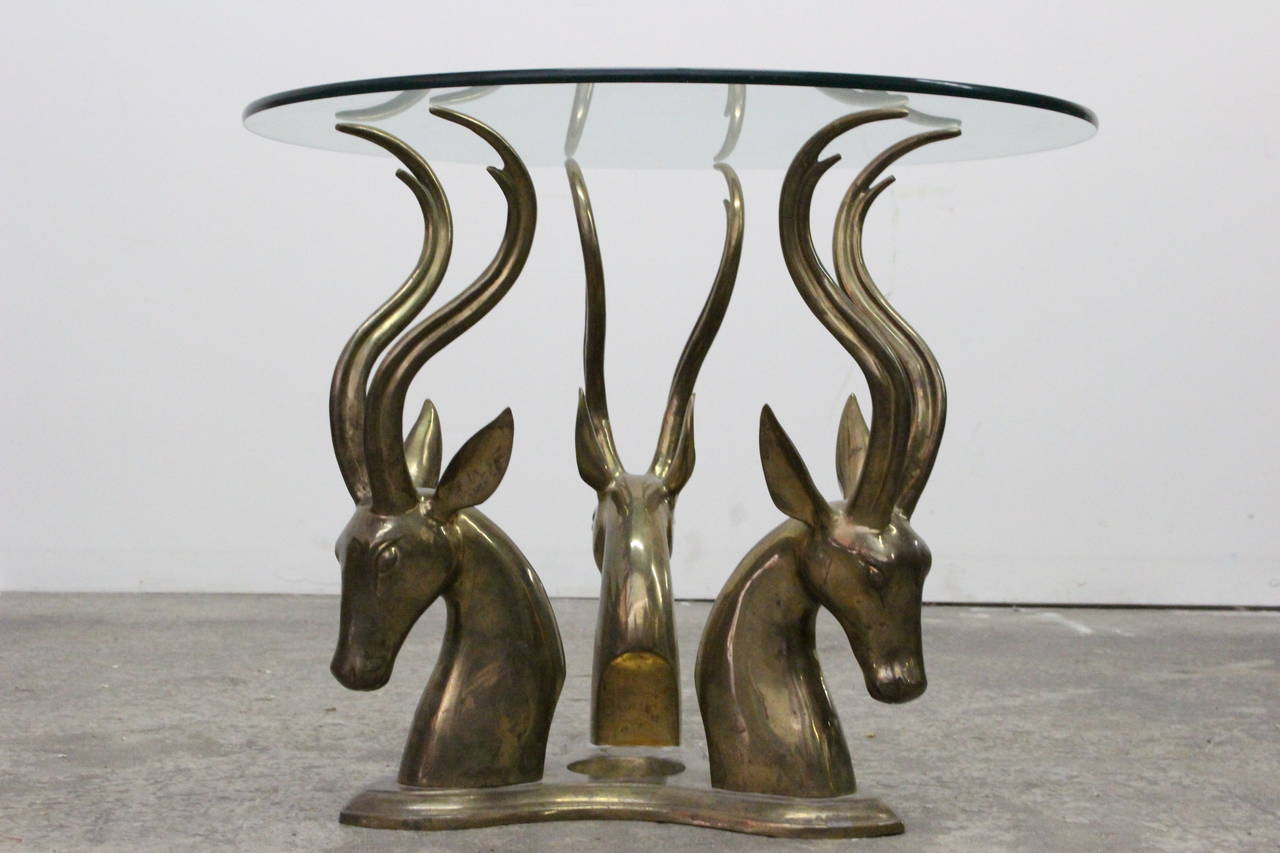 Single brass gazelle cocktail or coffee table. Brass has an aged patina, circa 1970s.

Dimensions: 24
