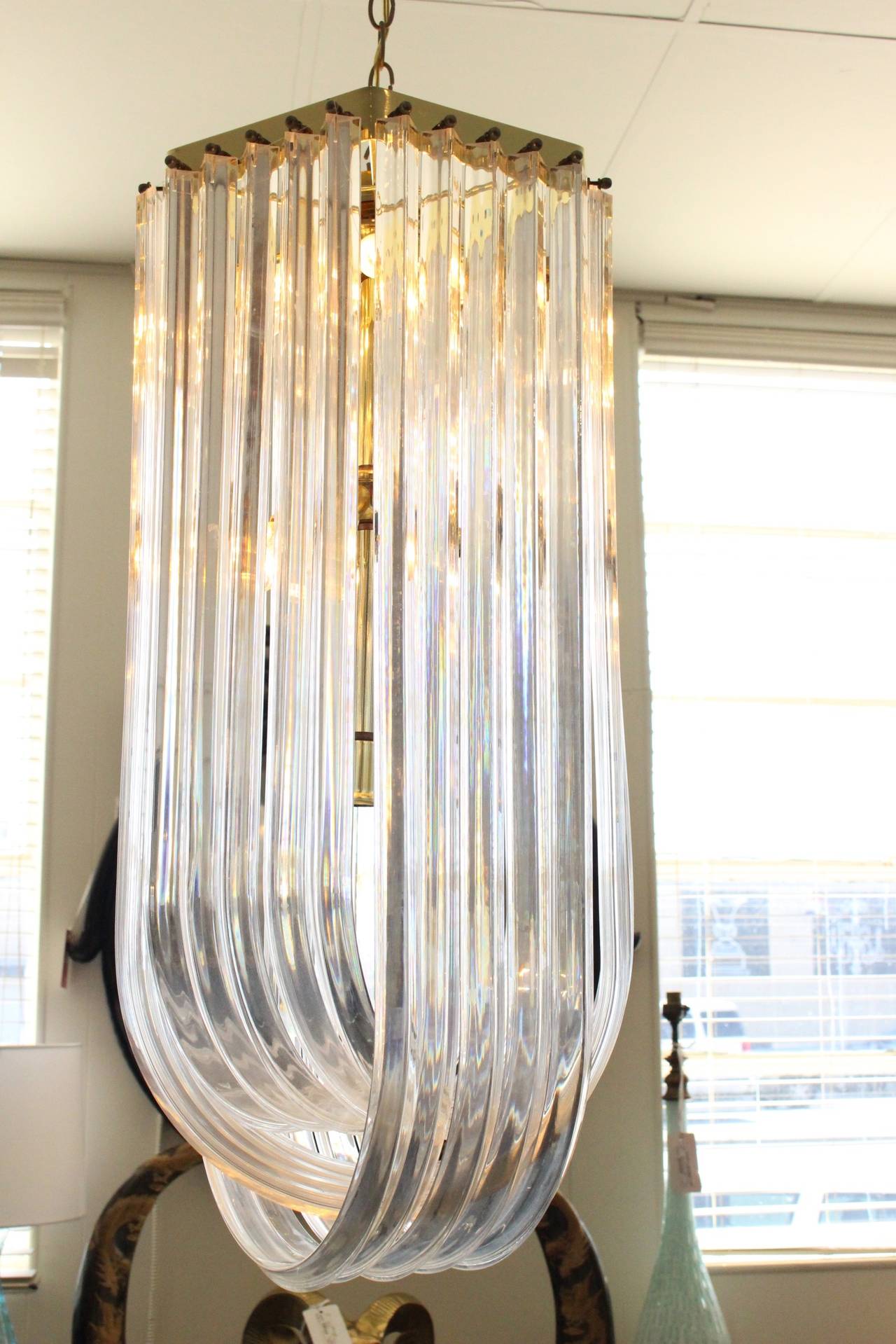 Large drop loop Lucite chandelier. There are fifteen light receptacles.

Dimensions: 16