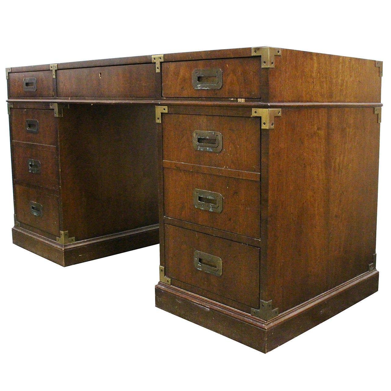 Campaign style desk with brass accents. The desk needs some love and would be perfect with a lacquer finish. There are seven drawers with two drawers for hanging files.

Dimension: 54
