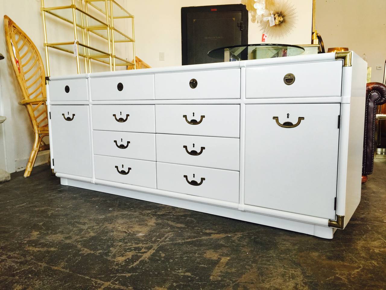 Newly lacquered campaign dresser by Drexel in white. This dresser has ample storage with ten drawers and two doors with shelving.

Dimensions: 77.5