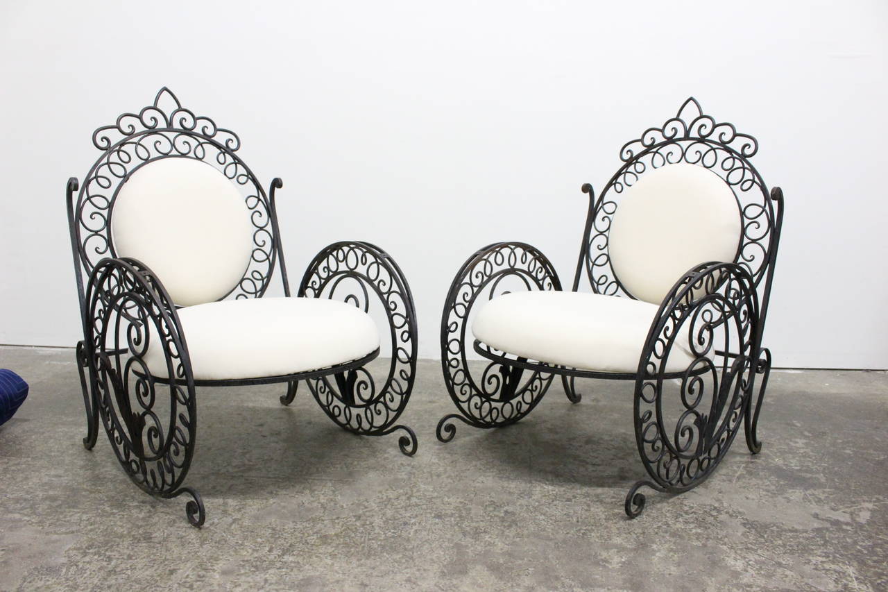 Pair of wrought iron chairs with upholstered cushions. 

dimensions: 28