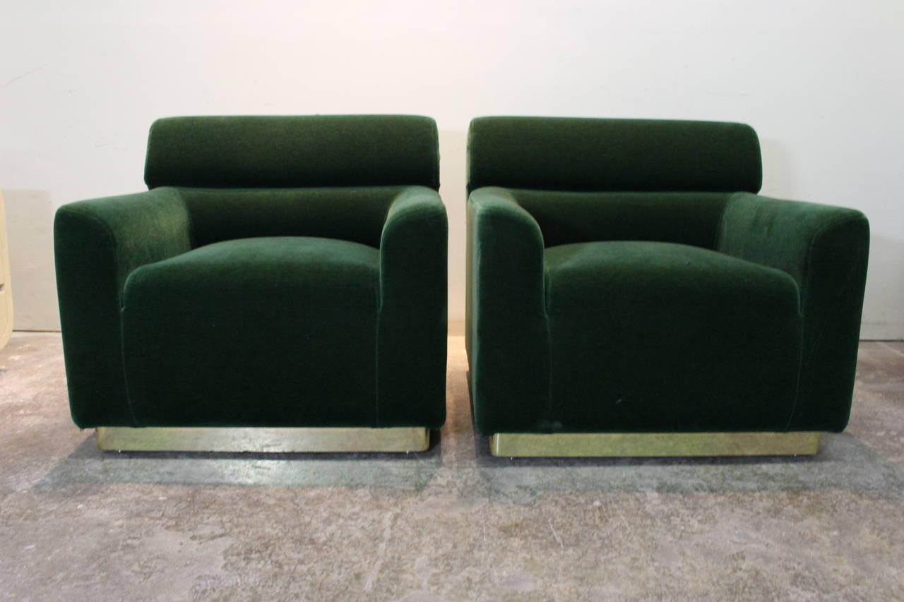 Pair of 70s green mohair club chairs. Each chair sits upon a brass plinth base. 

dimensions: 33