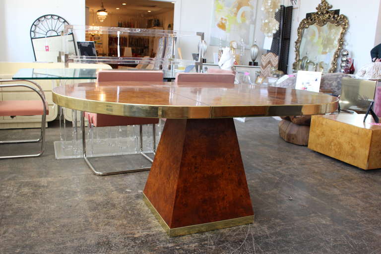 Burled walnut dining table, signed Pierre Cardin. Round table with one leaf and pedestal base.