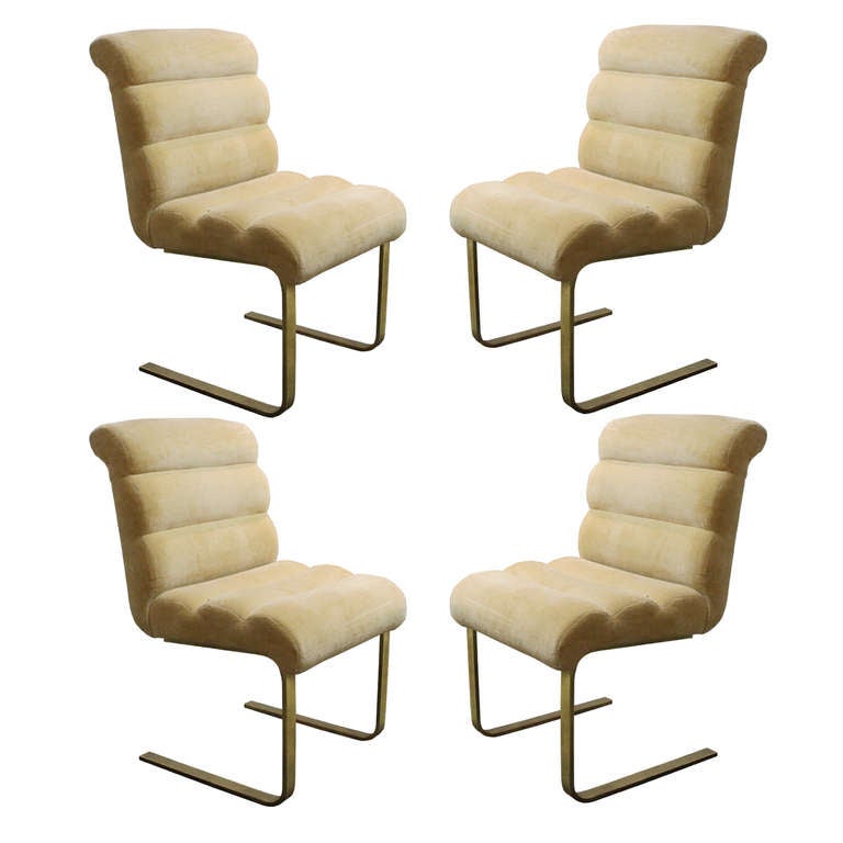 Set of four comfortable cantilever Lugano dining chairs by Mariani for Pace Collection. Cream upholstery on frame with lacquered brass legs.