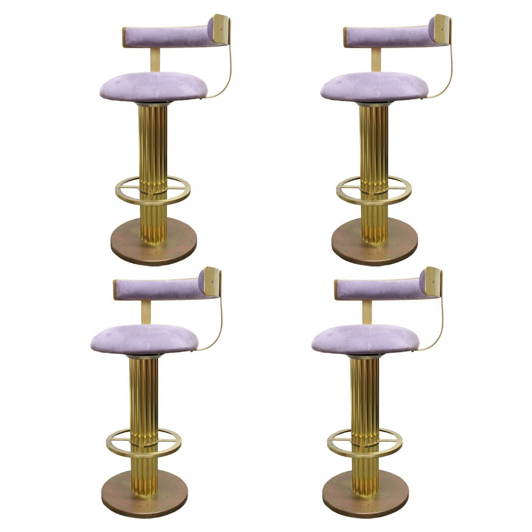 Set of four brass bar stools by Design for Leisure. Upholstered in lilac suede. Heavy gauge brass, circa 1980s.