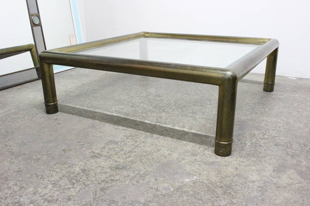 Monumental brass and glass coffee table by Mastercraft. Has original patina, circa 1970s.

Dimensions: 42" x 42" x 16".