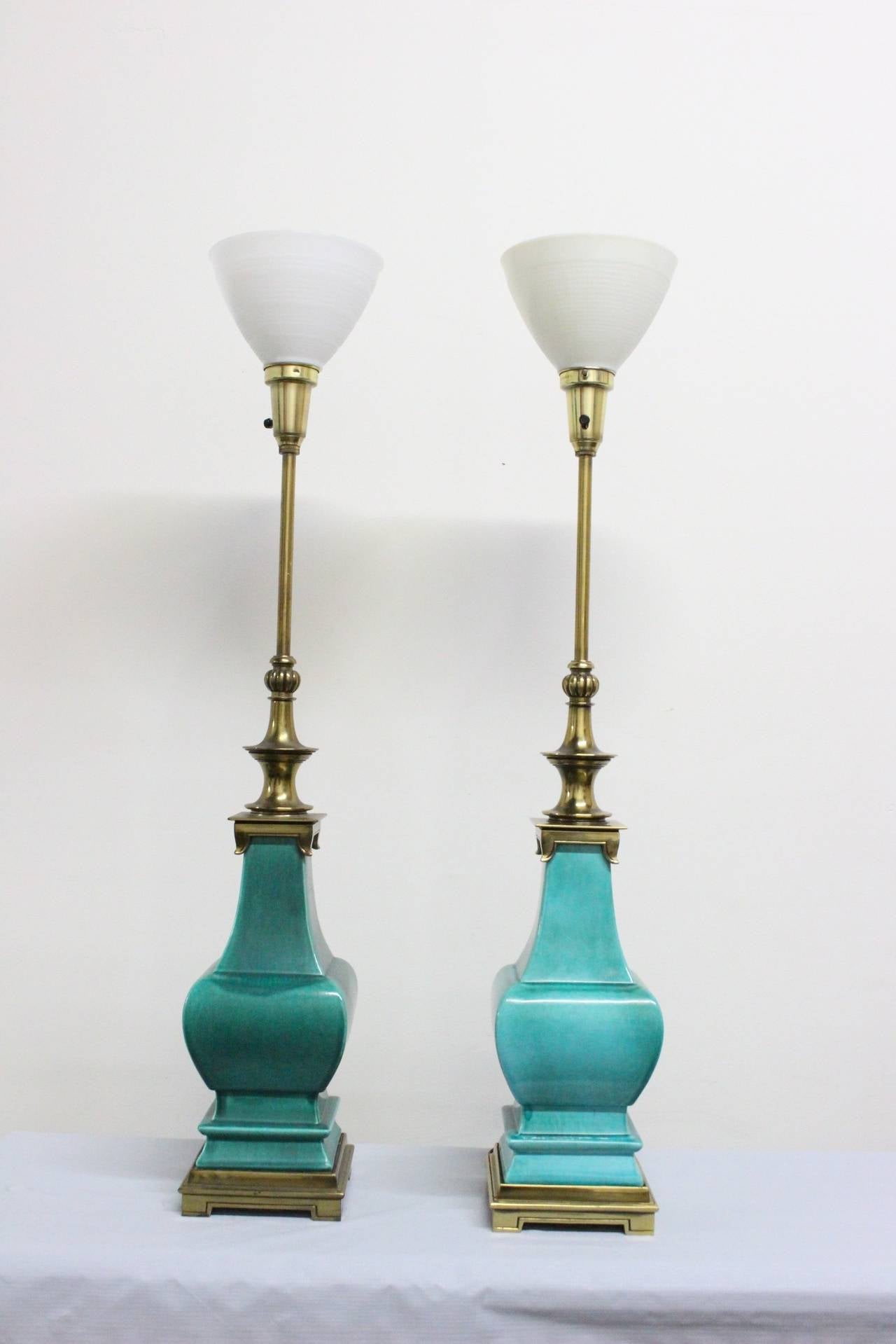 Pair of Stiffel porcelain glazed lamps. Lamps have brass bases and necks with torchiere tops, circa 1960s.

Dimensions: 7" x 7" x 42".