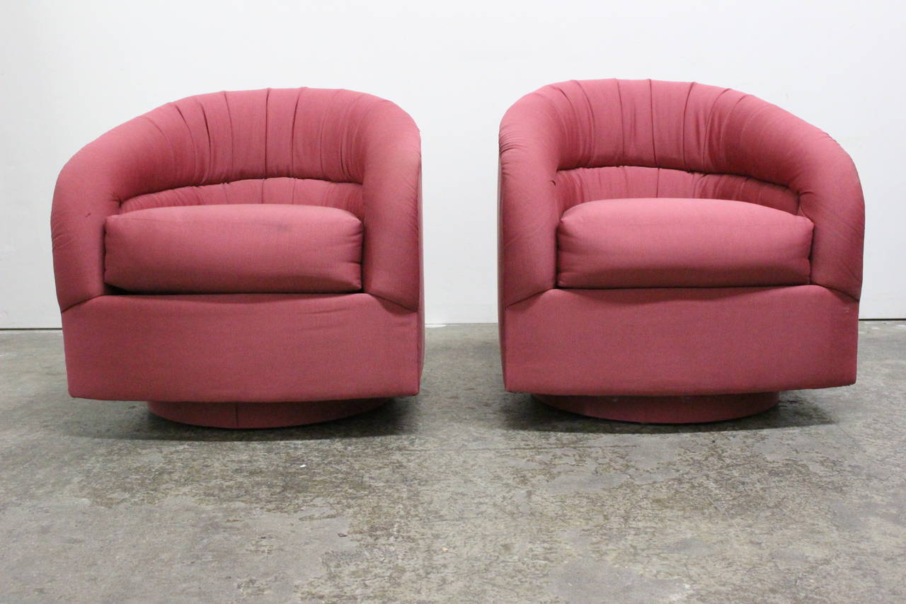 Pair of red swivel chairs by Directional. Swivel plinth base upholstered in same upholstery fabric.

Dimensions: 28