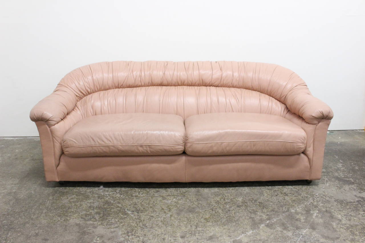 Worn patina leather sofa in a soft blush color. Ruched back, circa 1980s.

Dimensions: 80