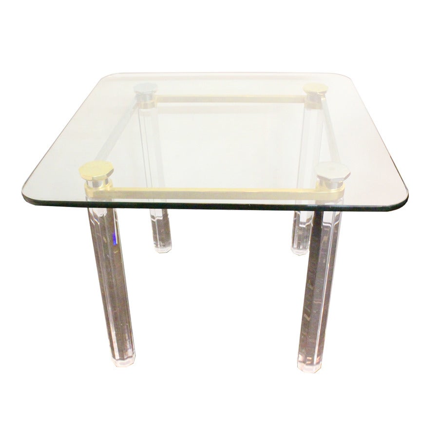 Game table with Lucite legs and has chrome and brass metal accents. Half inch square glass top with rounded edges. Minor surface abrasions on glass in Lucite.