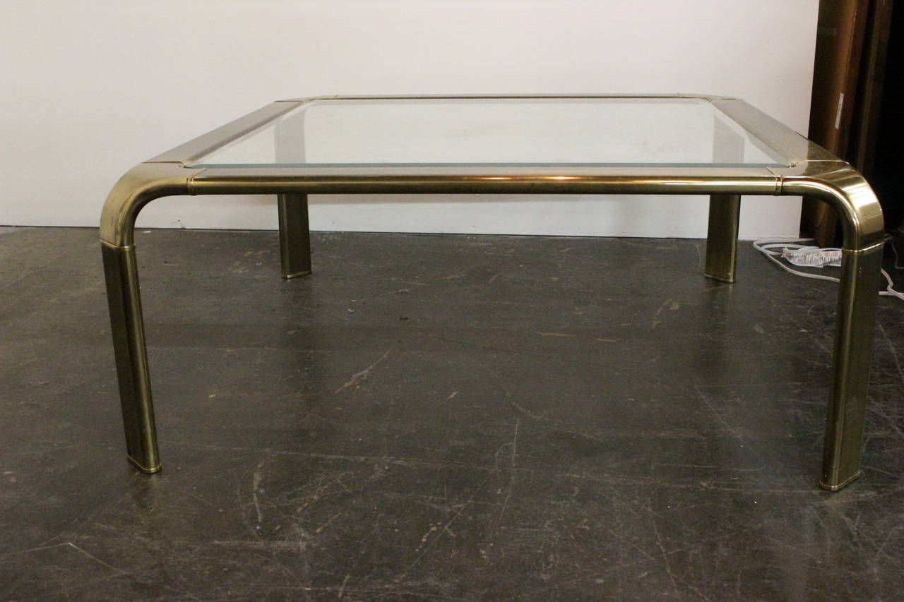 Brass Waterfall Coffee Table by John Widdicomb. Graceful curved legs with beveled glass top.

dimensions: 38" x 38" x 16"