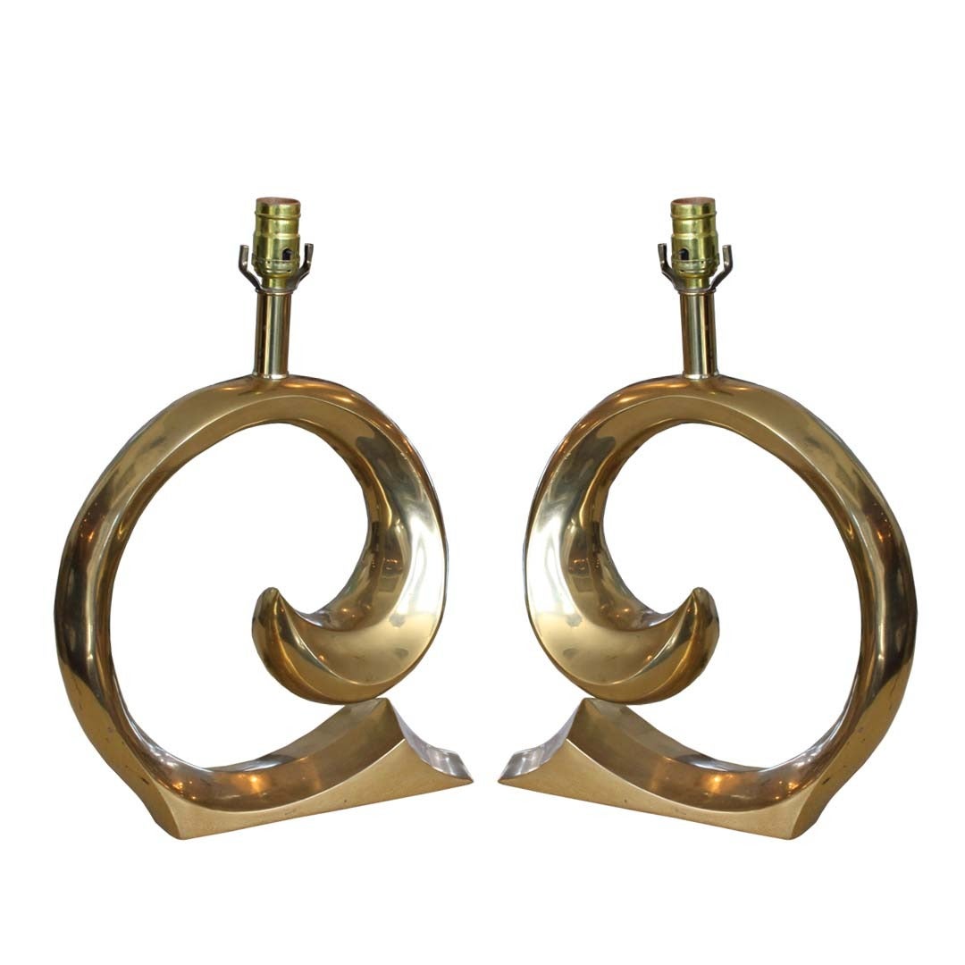 Pair of circa 1970's brass sculptural scroll lamps designed by Pierre Cardin Home Collection. They are in good vintage condition with age appropriate wear. There are some pitting and surface abrasions on brass.

 dimensiosn: 15