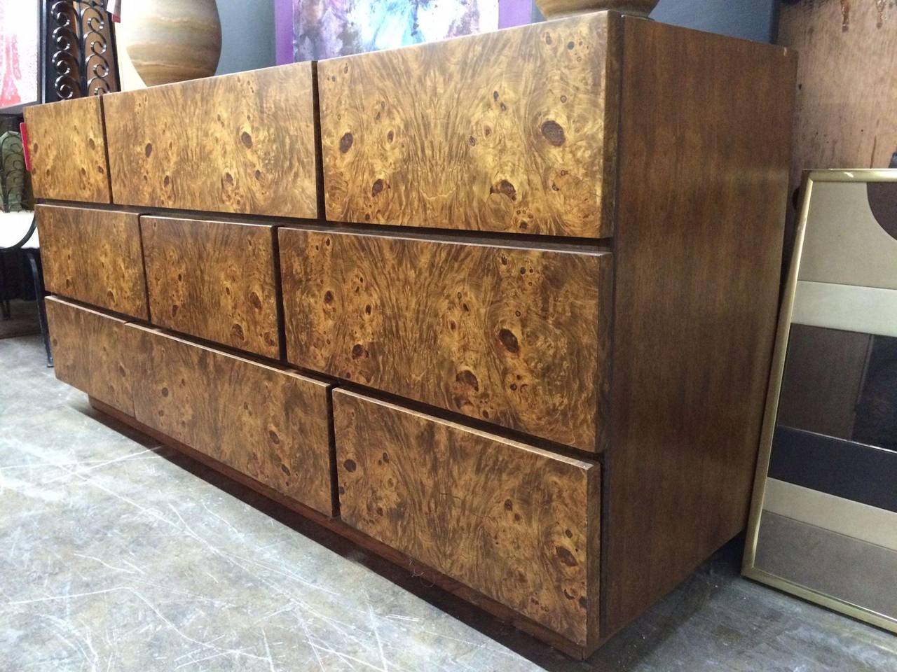 A dresser by Lane Furniture Company with burl wood flat drawer front panels. This handsome fella has nine drawers that are in a brick pattern which makes it unique. There is ample storage for all you personal belongings. There are some minor nicks