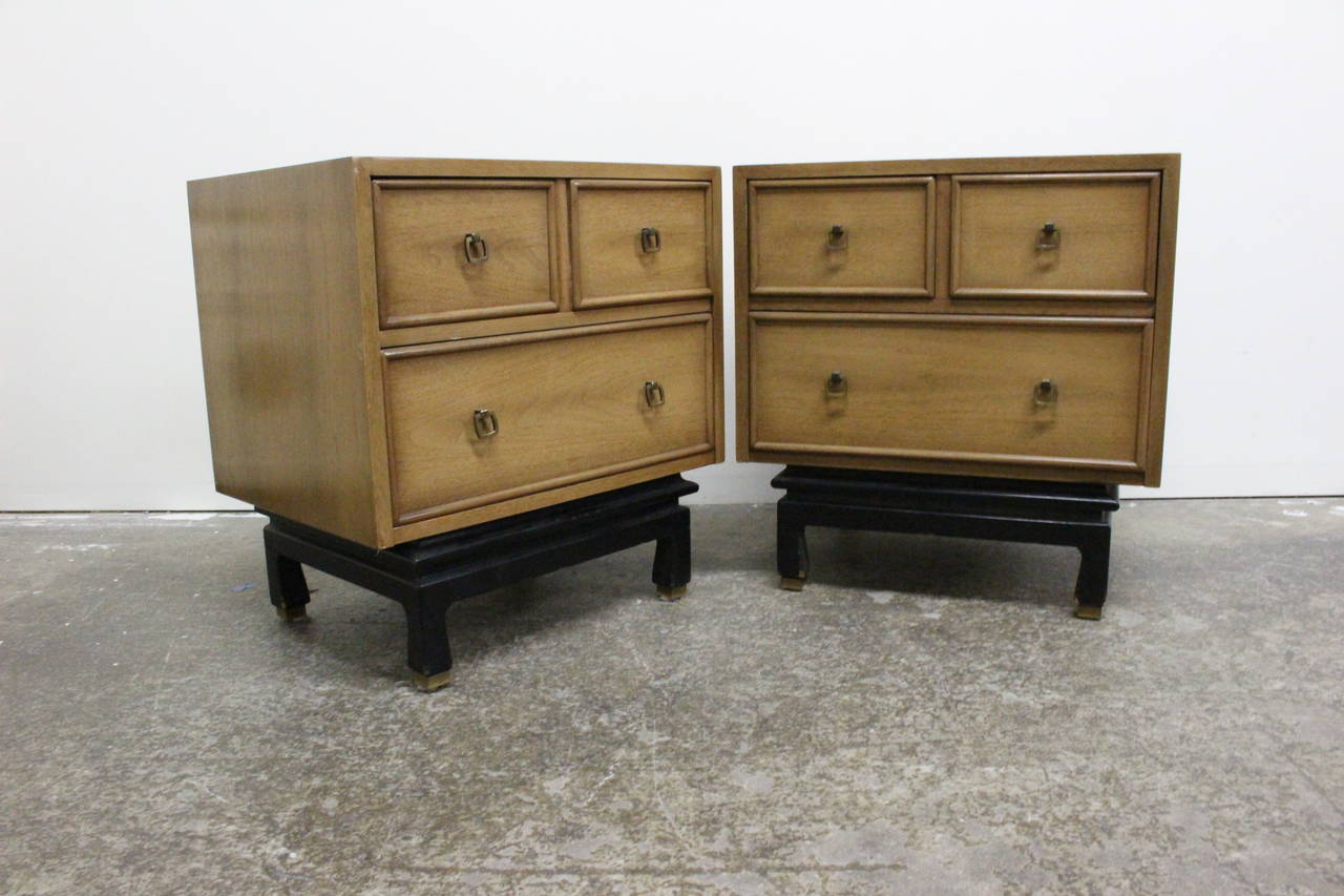 Pair of petite American of Martinsville nightstands with black lacquered base. Marked with the 