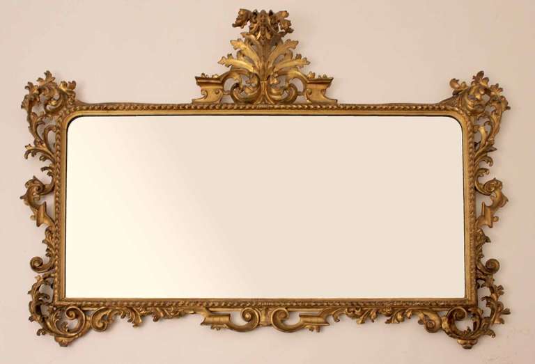 A beautiful 19th century Italian Florentine gilt carved wood overmantel mirror with its original bevelled mercery glass plate.