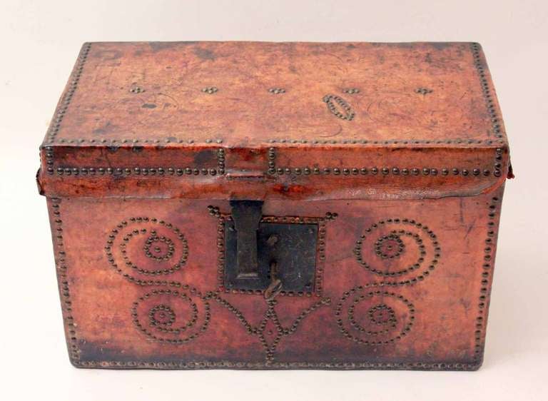 A beautiful early 19th century / possible 18th century leather trunk with brass stud decoration.  The leather has a fantastic colour and the trunk comes with its original lock and key.  We believe it was relined and repaired in a blue and white