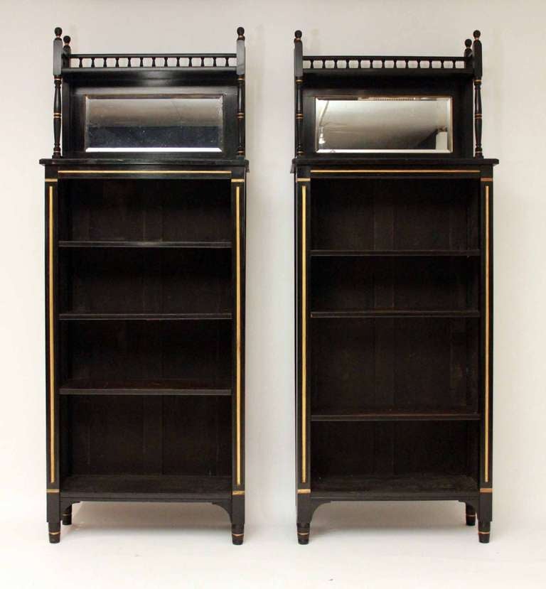 A rare set of four ebonised bookcases in the manner of Lambs of Manchester.  All four bookcases are in perfect condition.
The top mirror section is detachable and the shelves are adjustable.
