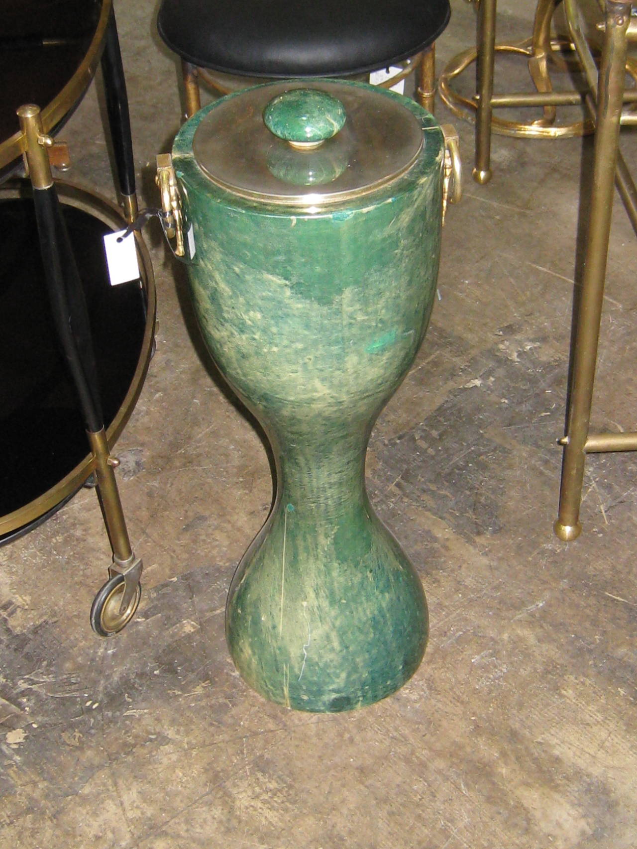Aldo Turo lacquered goatskin standing ice bucket in green-blue color. Brass lid upon shaped body with plated brass ring handles.
