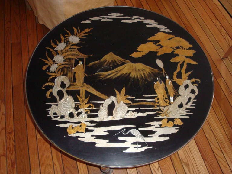 This is a 1970s gold and silver leaf painted Asian inspired round cocktail table. A trouvailles creation was a handmade and one of a kind creation .