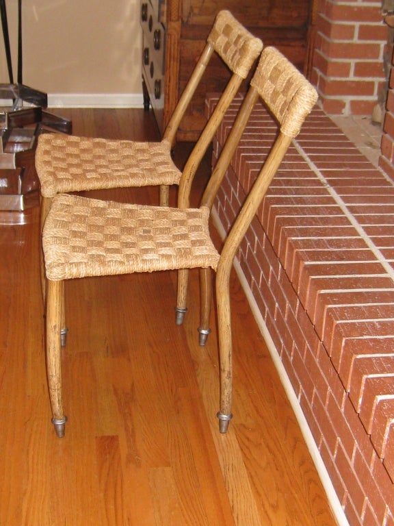Pair of Italian 1950s birch and rope side chairs attributed to Ico Parisi. The narrow backs connected by a woven seat and ending in slightly bowed legs.