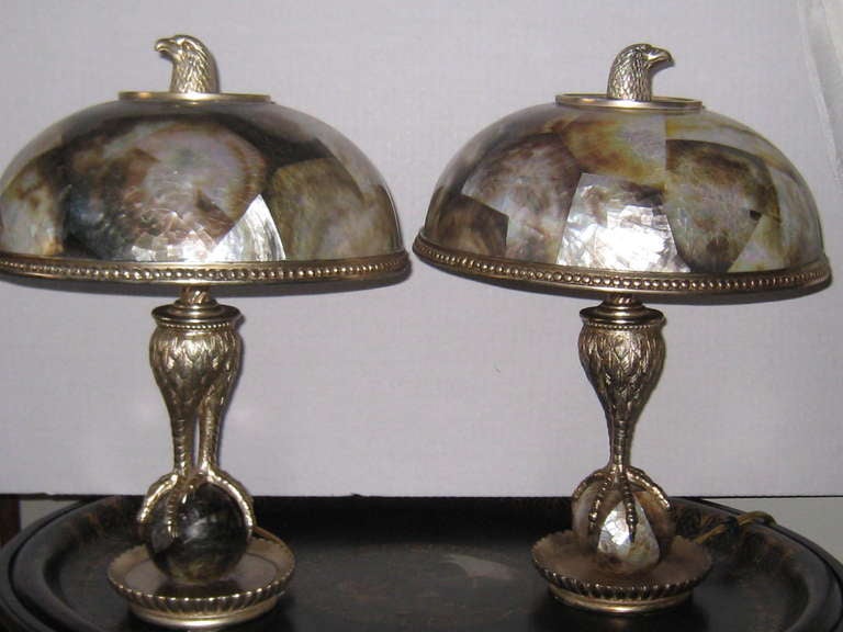 Pair of silvered Maitland-Smith lamps having penshell shades and figural bronze eagle finials. Handmade.