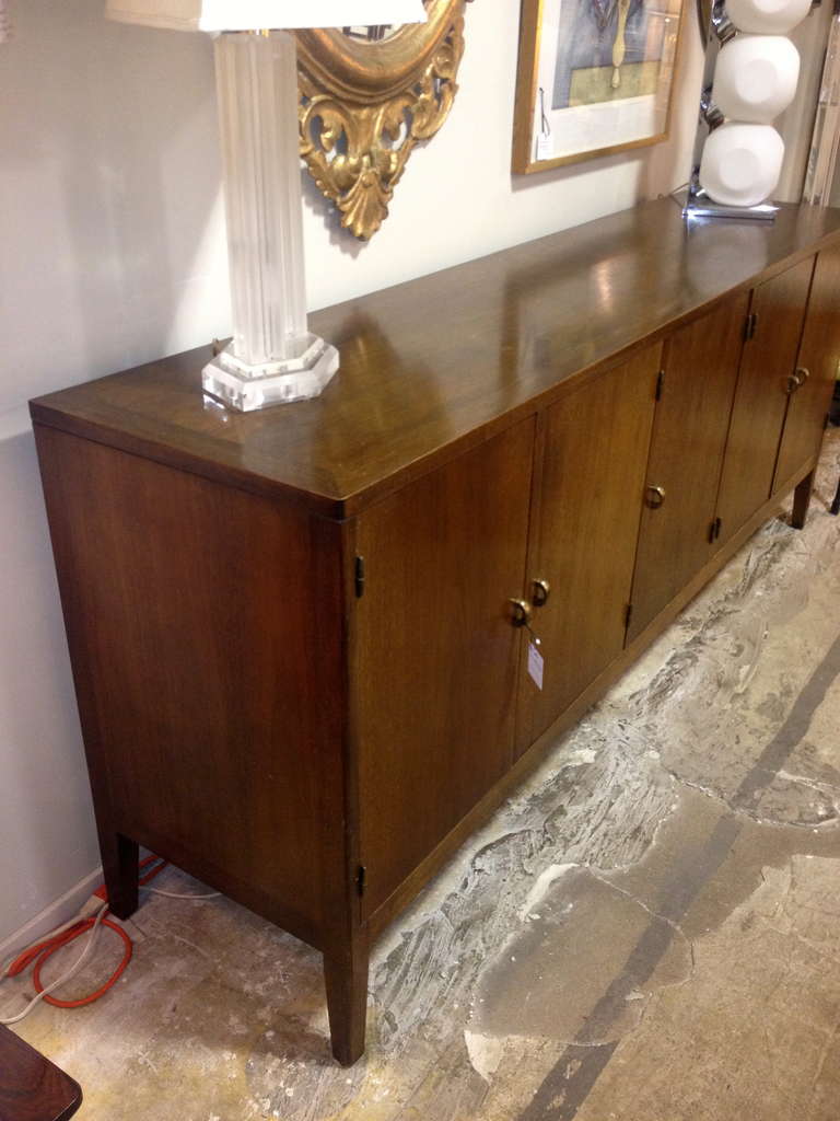 Sideboard or buffet or credenza by Romweber Furniture of Batesville, IN, circa 1970. In mahogany with original deep rich color and finish, this piece is the perfect example of Romweber's reputation for large-scale functionality and quality. Behind