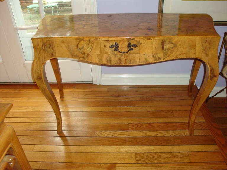 This is a lovely olive wood desk from the 1960s probably made in italy.