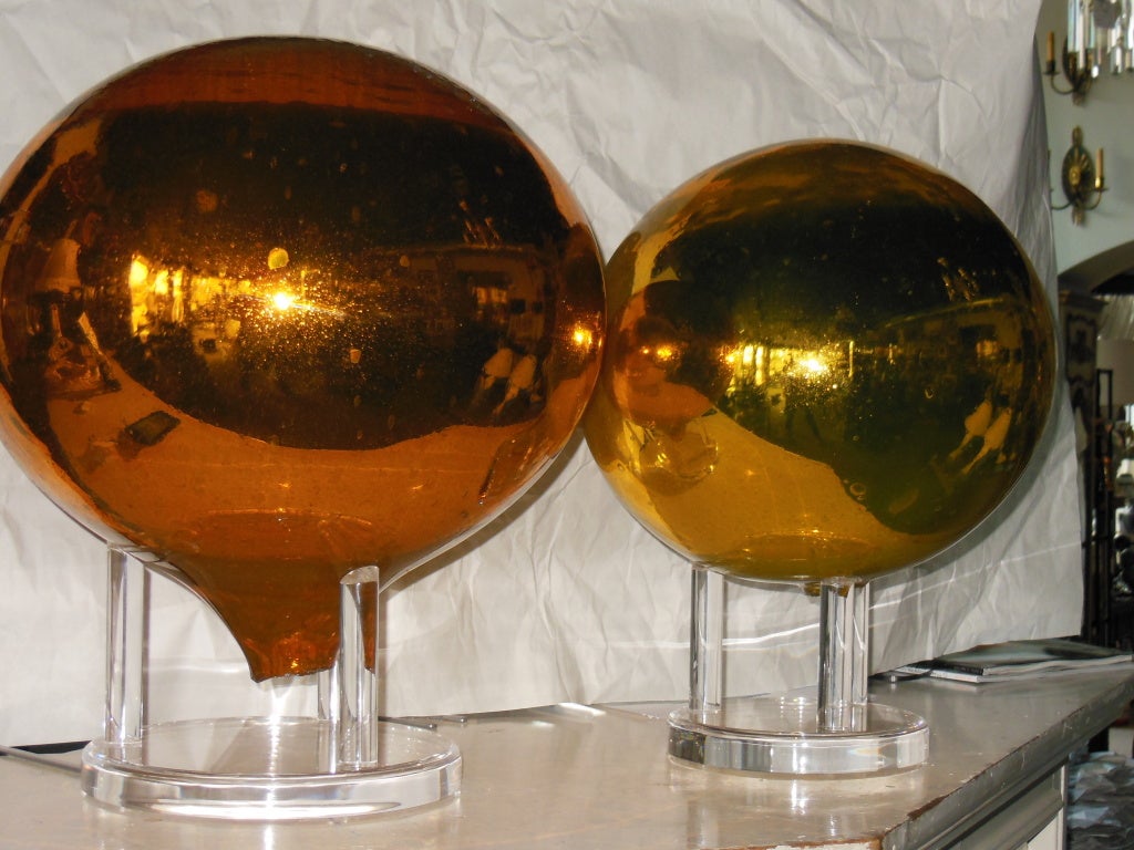 Great mercury glass balls on custom stands.The largest ball is 18 1/2 inches high, with a diameter of 48 inches. The medium mercury ball is 16 inches high, with a diameter of 40 inches.