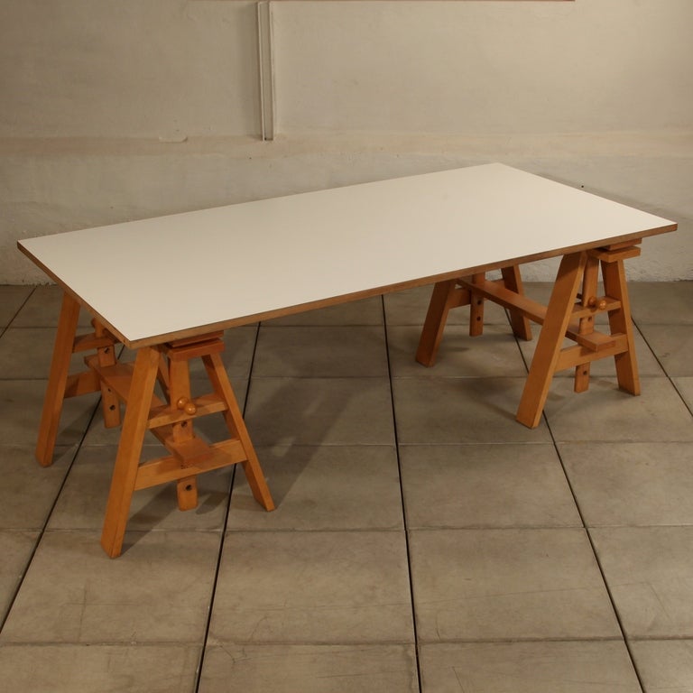 Old 'vintage' Leonardo table, design by Achille Castiglioni for Zanotta 

This work table feels like an artisan's and look like a designer's. The height is adjustable. The frame is in steam-treated beech wood. The top is available coated in white