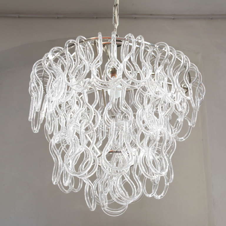 Fab. chandelier with 3 layers of interlocking glasses . The lenght of the chandelier can be adjusted by adding/ removing glasses. 
Hangingheight is 100 cm but can be adjusted (shortening the metal chain).
Body is 50 cm of height.