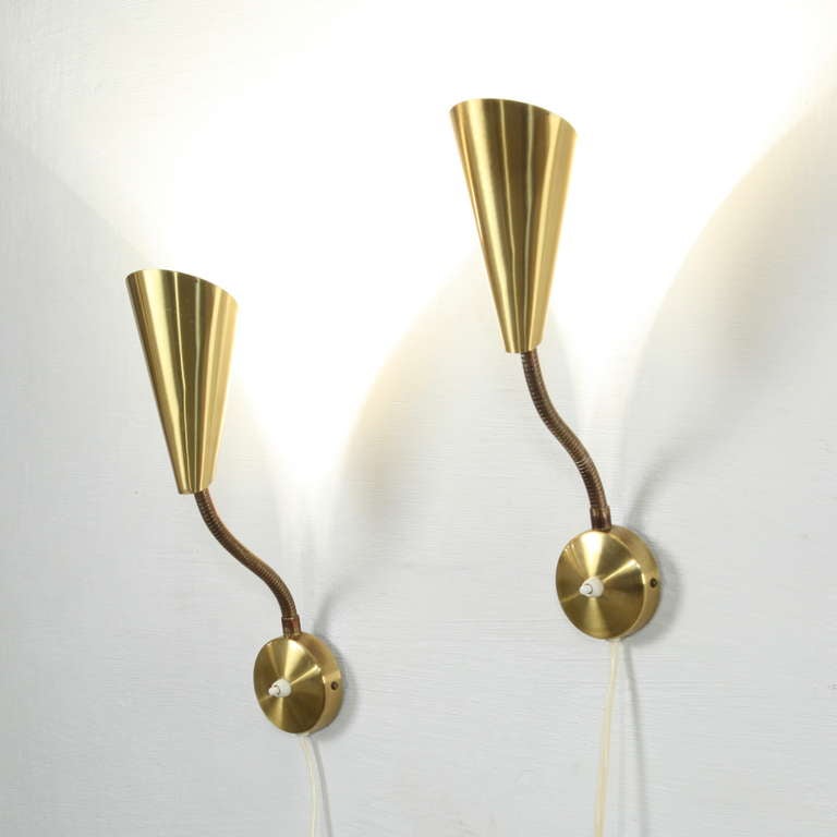 Set of brass mid century Scandinavian wall lamps.  Easy to fix on the wall.  Orientable brass shades.  In mint condition.