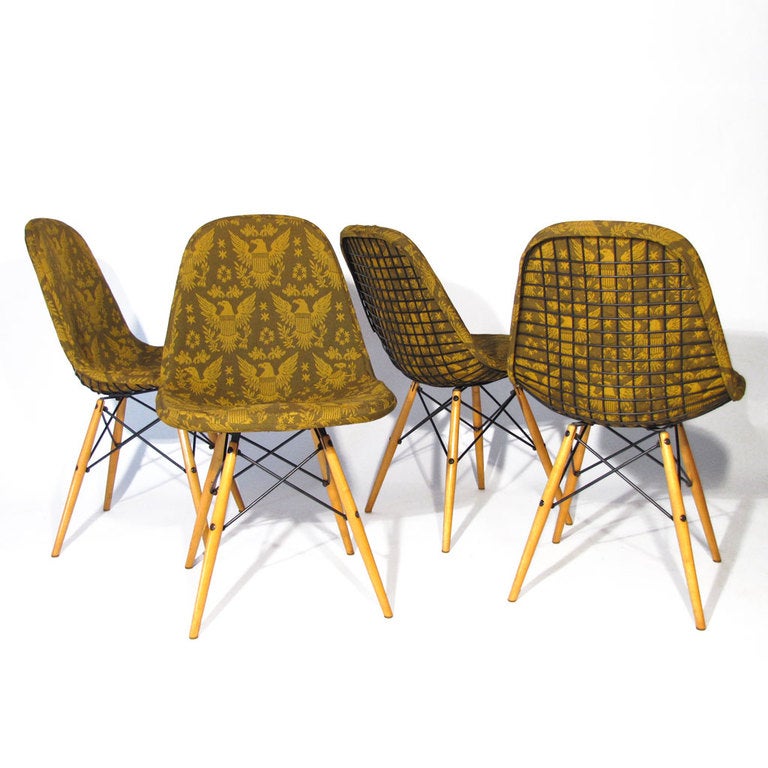 Four Charles & Ray Eames for Herman Miller dowel base DKW desk, dining, or accent chairs with birch legs supported by steel framework. All original parts with all feet intact. Full custom original olive and deep gold Federal Eagle print upholstered