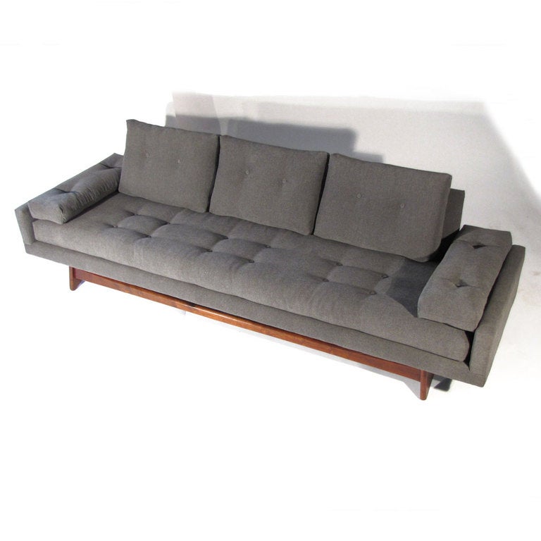 Classic Adrian Pearsall model 2408-S sofa. New symmetrical tufted upholstery in soft slate material. Beautiful rich walnut base. The particular model of Adrian Pearsall is very comfortable with back wedge form cushions and generous depth.