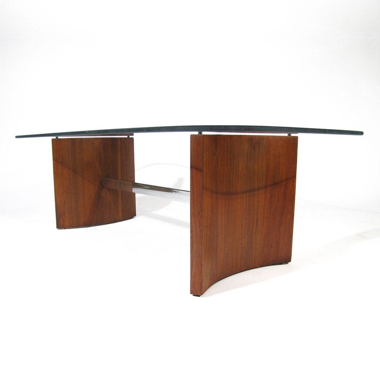 Sleek Vladimir Kagan for Selig coffee table. Two thick crescent walnut panels joined by a horizontal chrome bar. 

Restored condition. New glass.